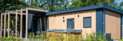 Modern houten huis met glazen details in bos.